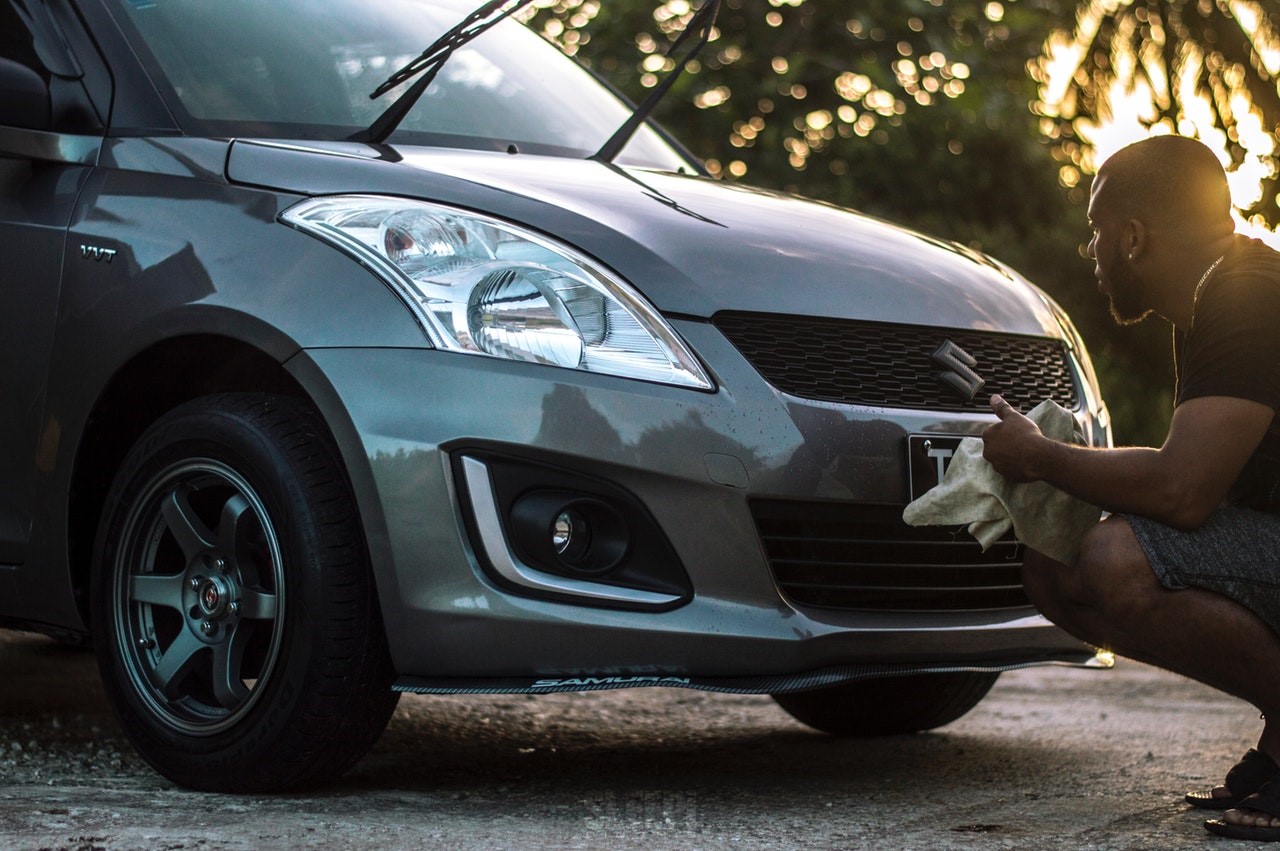 A Car Wash Cleaning Guy Making a Car Shiny Clean